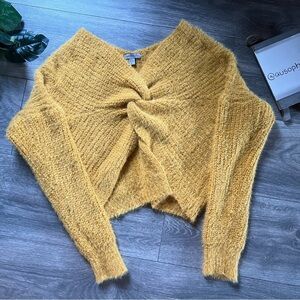 Casting La Coay Eyelash Yarn Twist Knot Sweater in Mustard. Size L